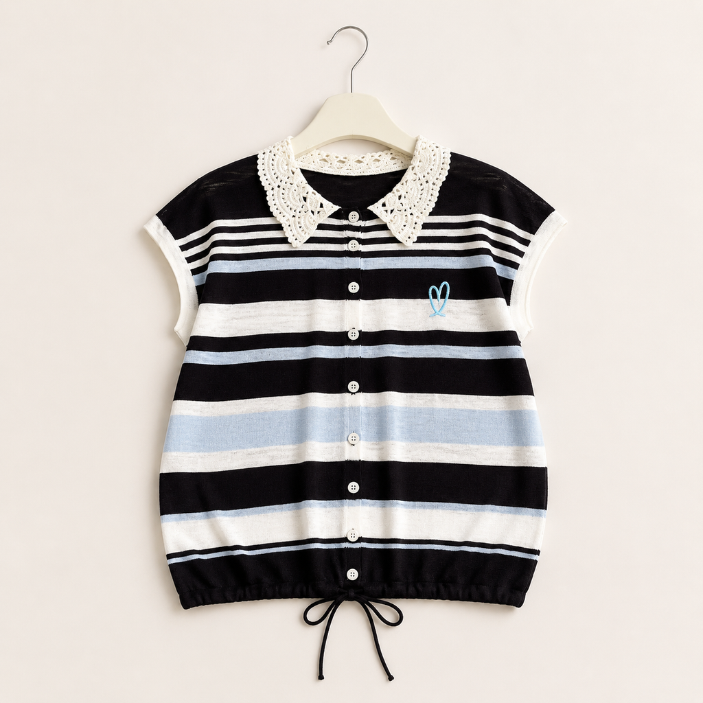A short-sleeve knit top, featuring horizontal stripes in black, white, and light blue, with a white crochet collar and a small light blue embroidered heart on the chest. It is shown hanging on a wooden hanger against a light beige background.
