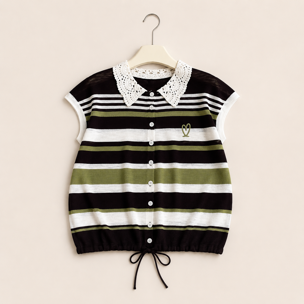A sleeveless knit top with horizontal black, white, and olive green stripes, featuring a white lace Peter Pan collar, a button-up front, and a small embroidered heart on the chest, hanging on a wooden hanger against a light beige background.